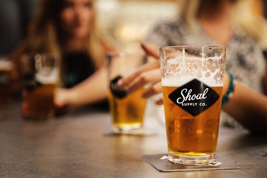 A Shoal Supply Co. pint glass on the bar